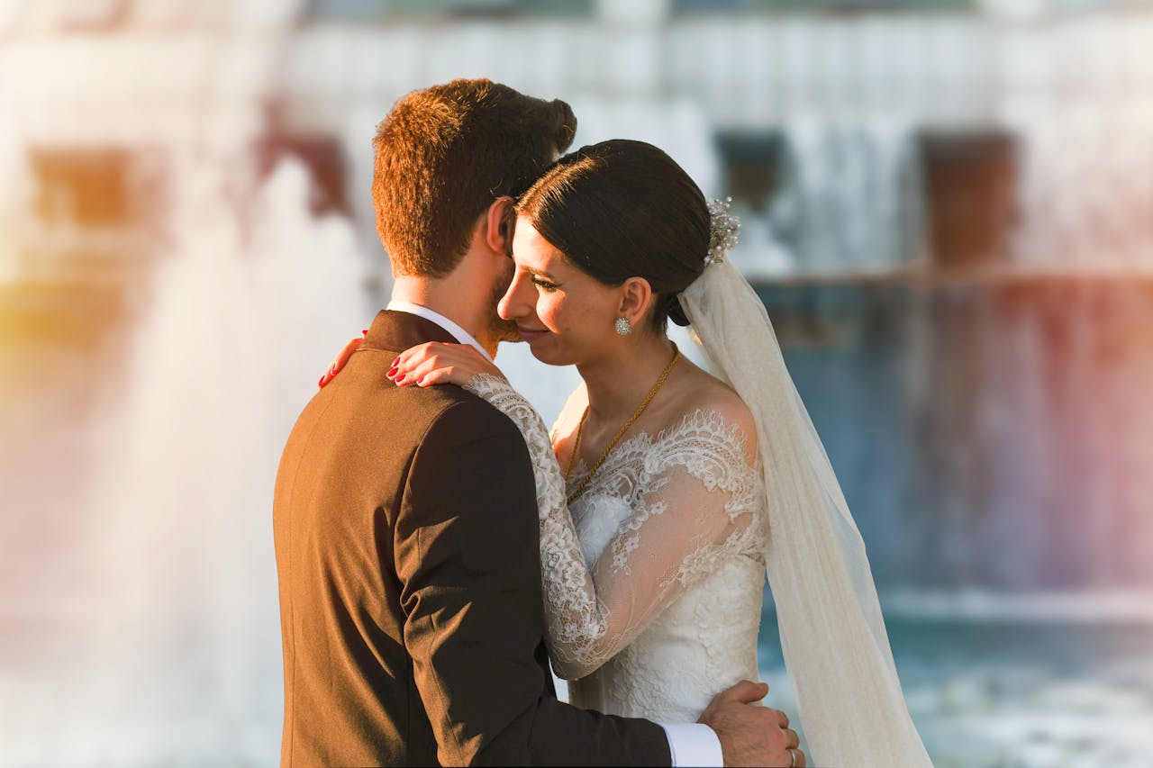 A romantic moment with a bride and groom embracing near a beautiful fountain in Istanbul.